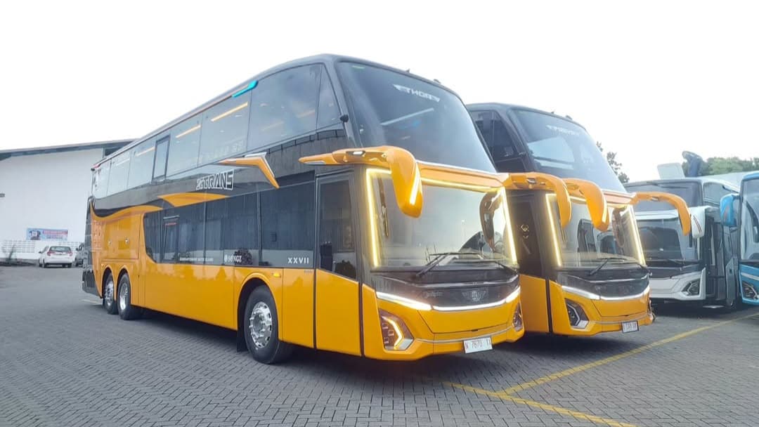 A bus on a scenic road during sunset, representing travel and journey.